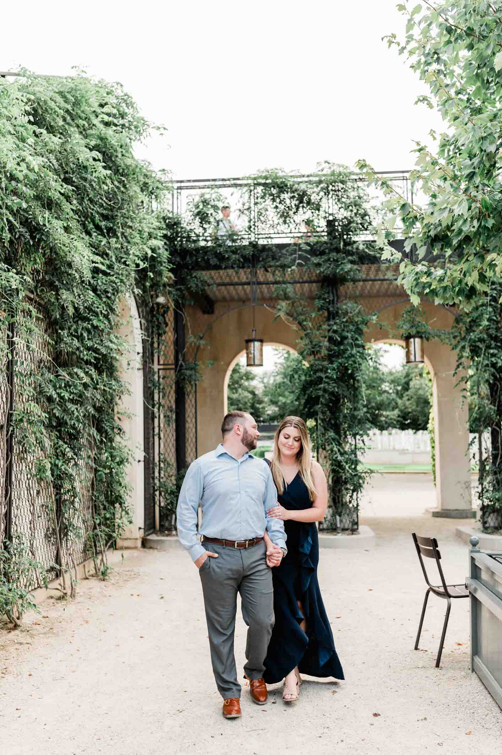 Romantic couple embracing amidst blooming flowers at Longwood Gardens, Philadelphia, Pennsylvania - Editorial Engagement Session