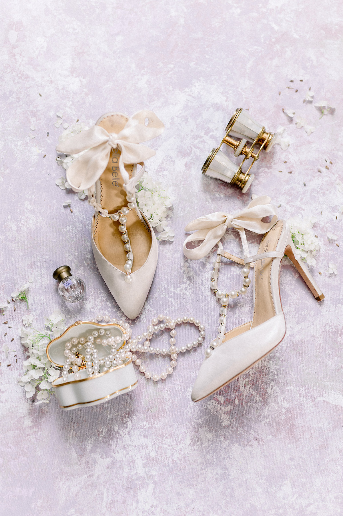 A captivating arrangement of Bella Belle shoes, delicately styled on a hand-painted backdrop, adding a touch of vintage charm to the editorial.