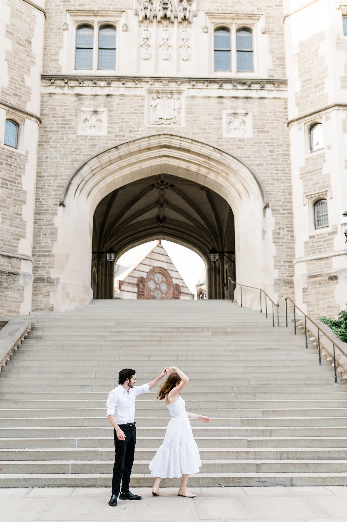 Engagement photoshoot at Princeton University: Page and Christopher sharing a tender moment under the iconic archway.