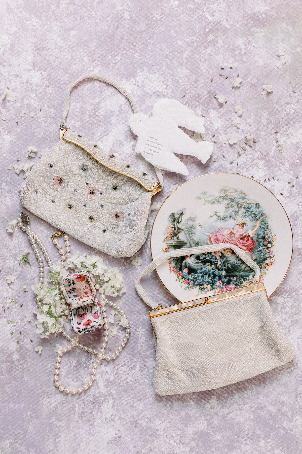 Close-up of intricate details showcased on a hand-painted backdrop, including vintage jewelry and delicate floral accents.