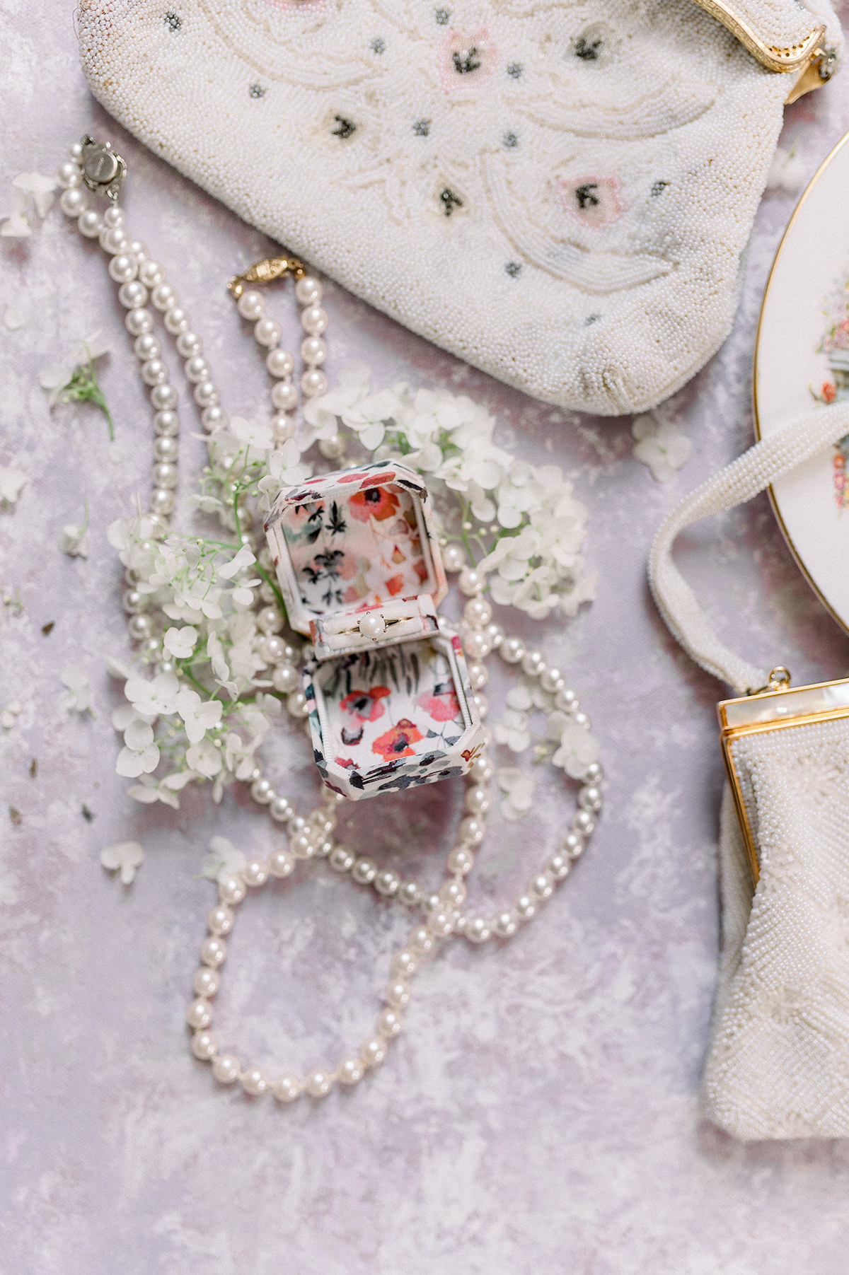 A top-down view of exquisite bridal accessories resting on a hand-painted backdrop, adding a touch of sophistication to the editorial.