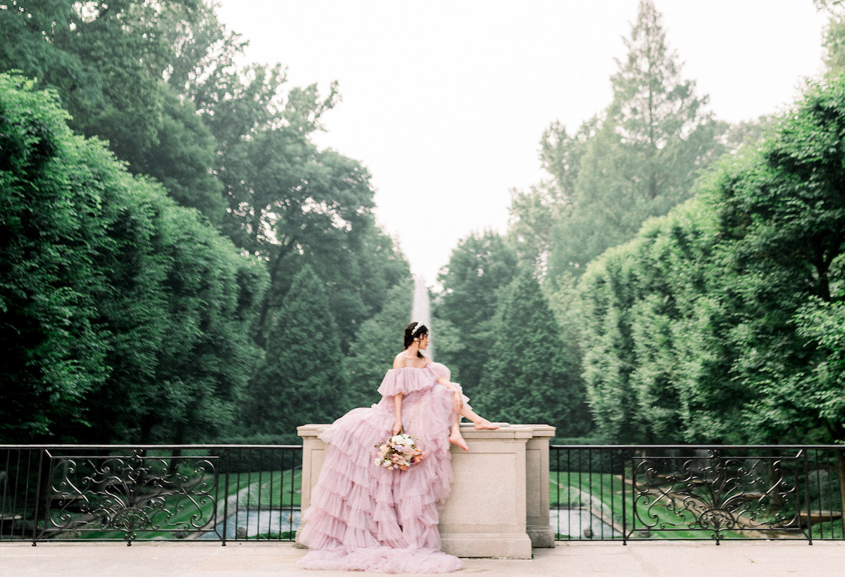Karla's high-fashion editorial pose in the couture gown adds a touch of drama and sophistication to the picturesque surroundings of Longwood Gardens.