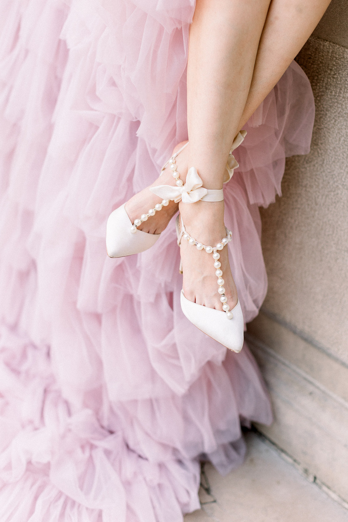 A close-up of Bella Belle shoes adorned with elegant pearl details, adding a touch of timeless sophistication to the bridal ensemble.