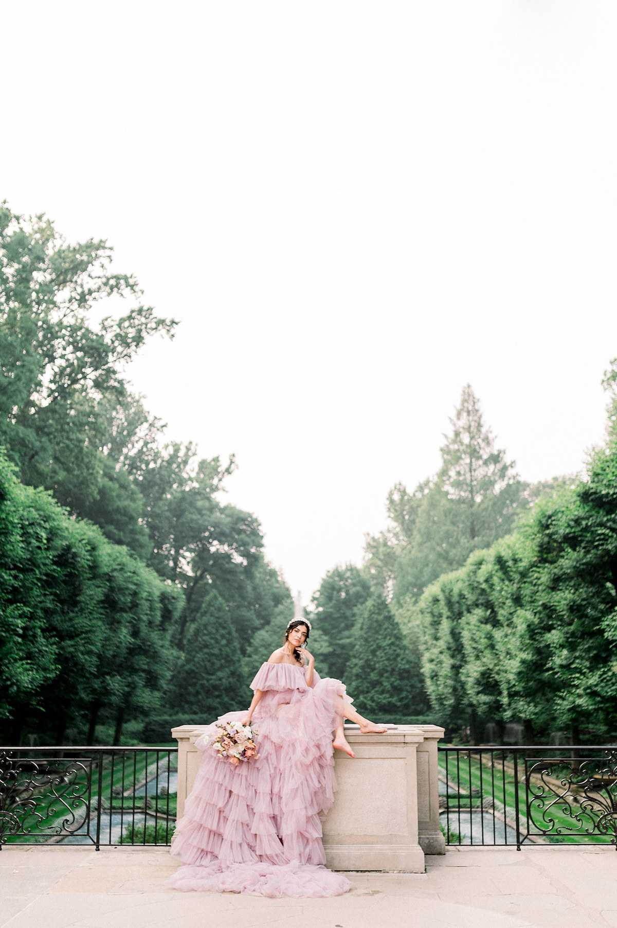 The couture gown transforms Karla into a vision of high-fashion chic, her commanding pose against the natural beauty of Longwood Gardens creating a captivating contrast.