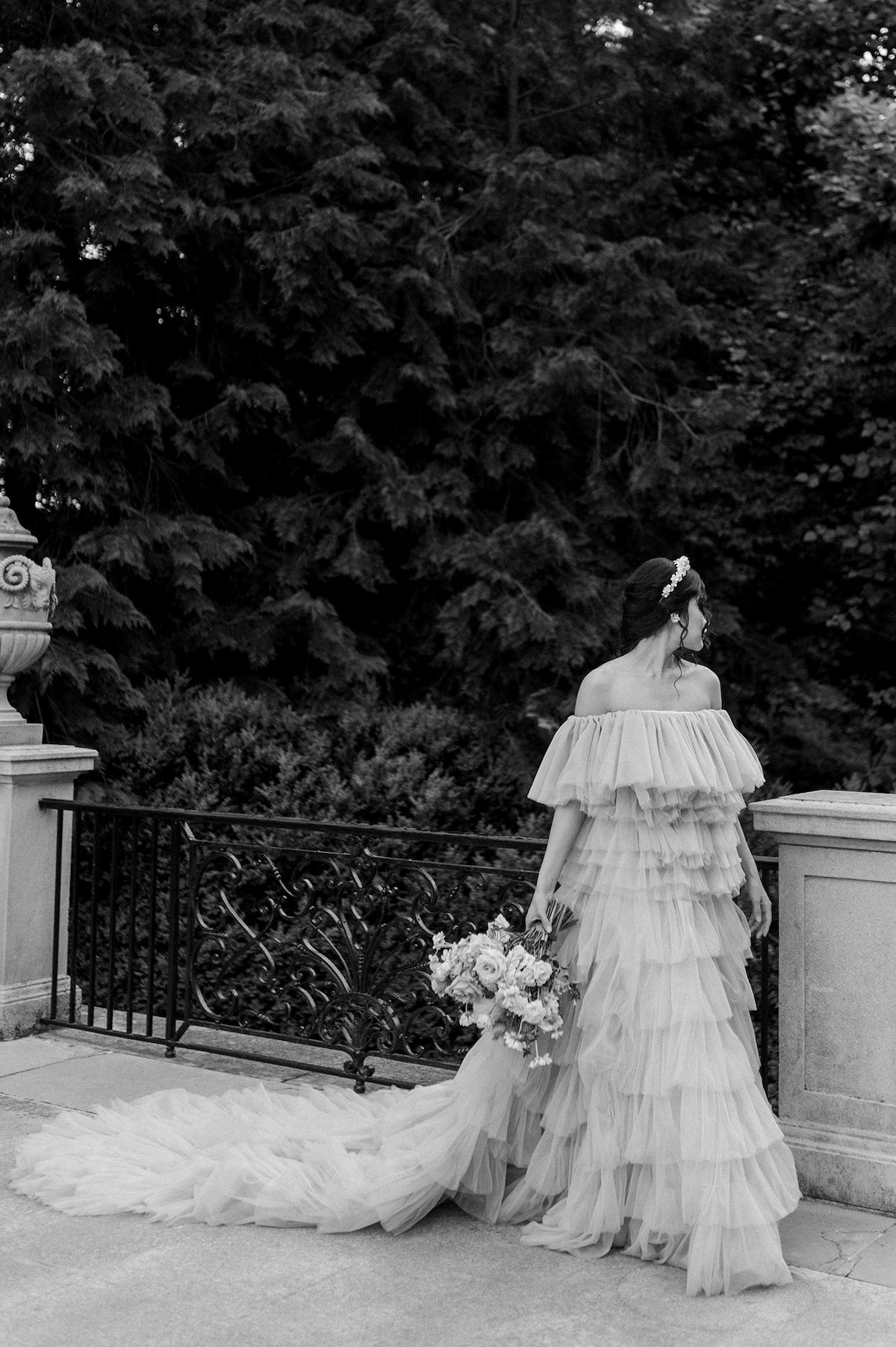 Karla's elegance is beautifully captured in black and white, the tiered mauve couture gown cascading gracefully as she stands in Longwood Gardens.