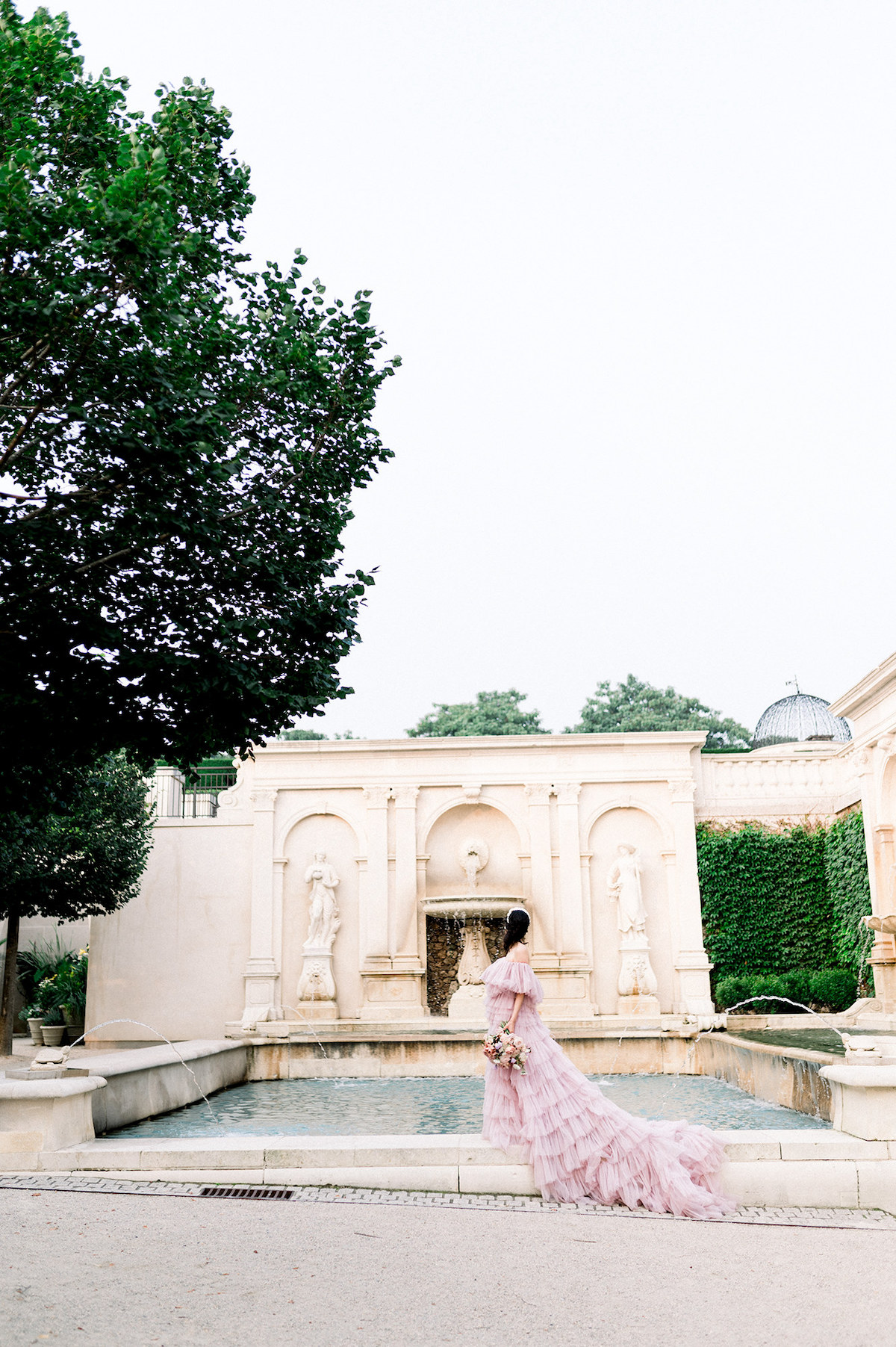Karla exudes high-fashion elegance in the couture gown, striking a fierce and confident pose amidst the enchanting backdrop of Longwood Gardens.