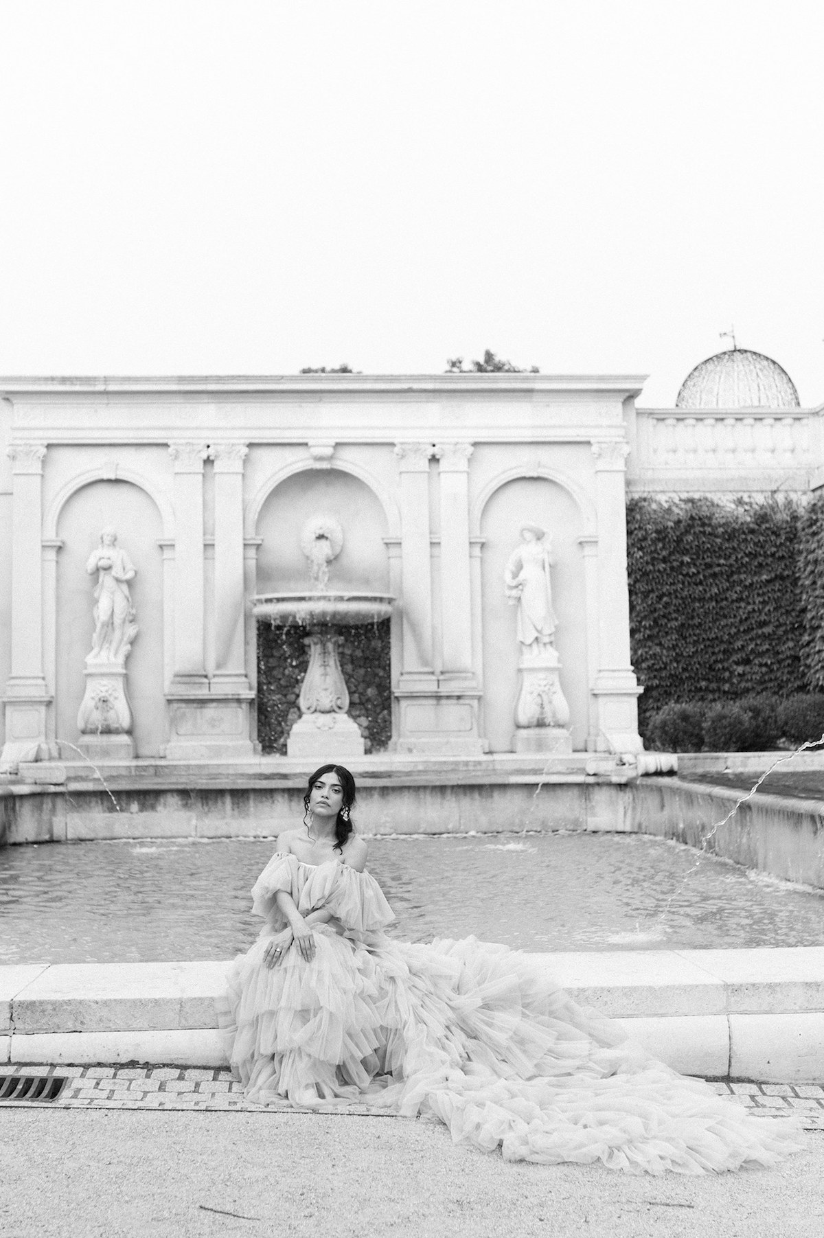 Karla, adorned in a tiered couture gown in soft mauve, radiates timeless beauty in a stunning black and white portrait at Longwood Gardens.
