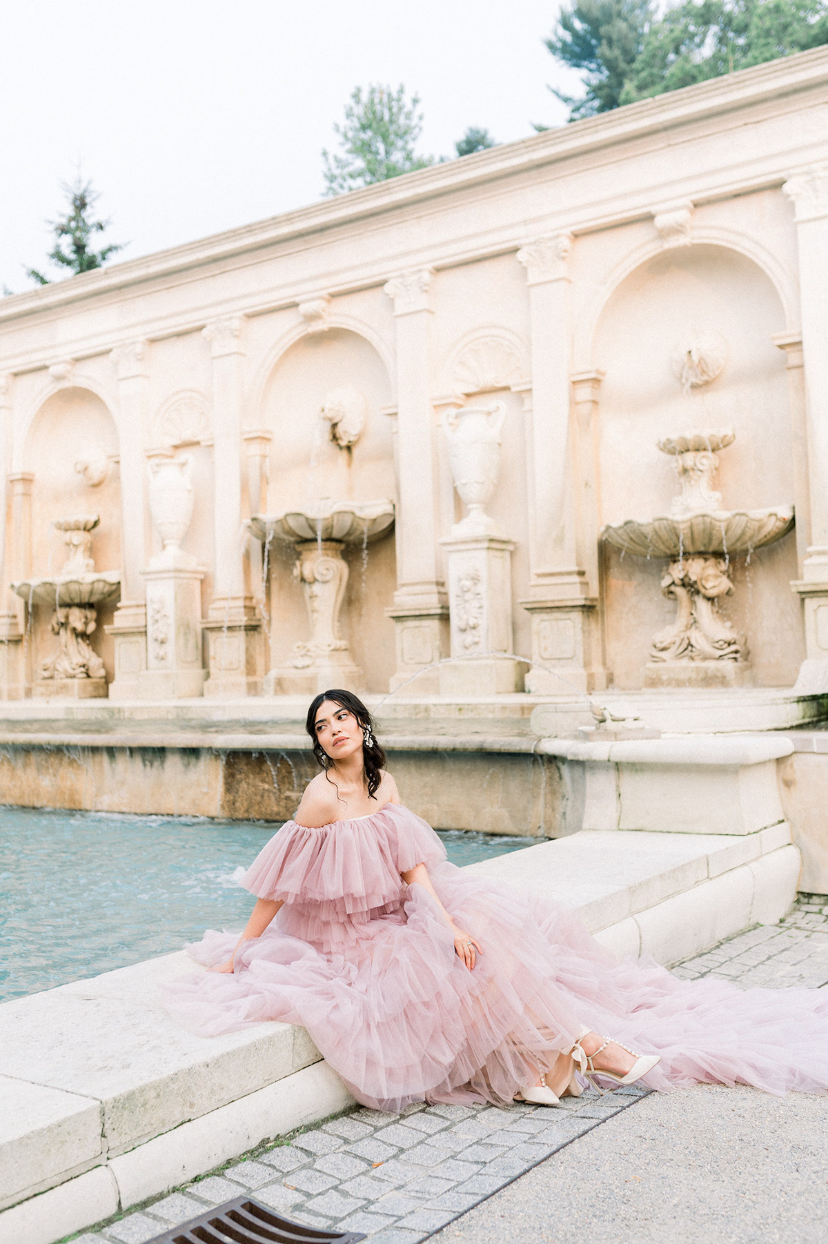 Karla's high-fashion editorial pose in the couture gown adds a touch of drama and sophistication to the picturesque surroundings of Longwood Gardens.