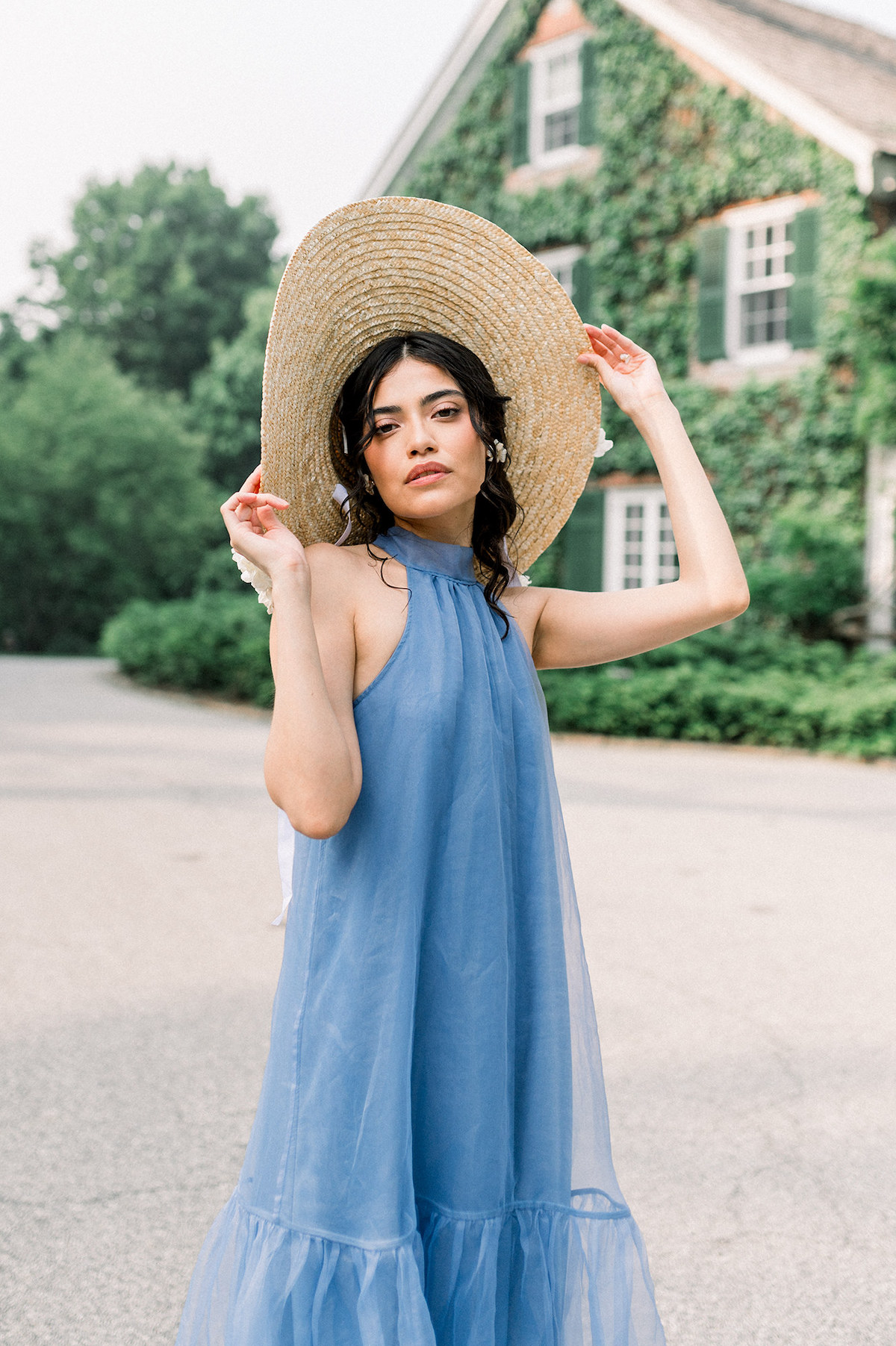 Karla, our model, wearing a French blue tea-length gown with a white hydrangea-adorned boat-style hat at Longwood Gardens, Pennsylvania.