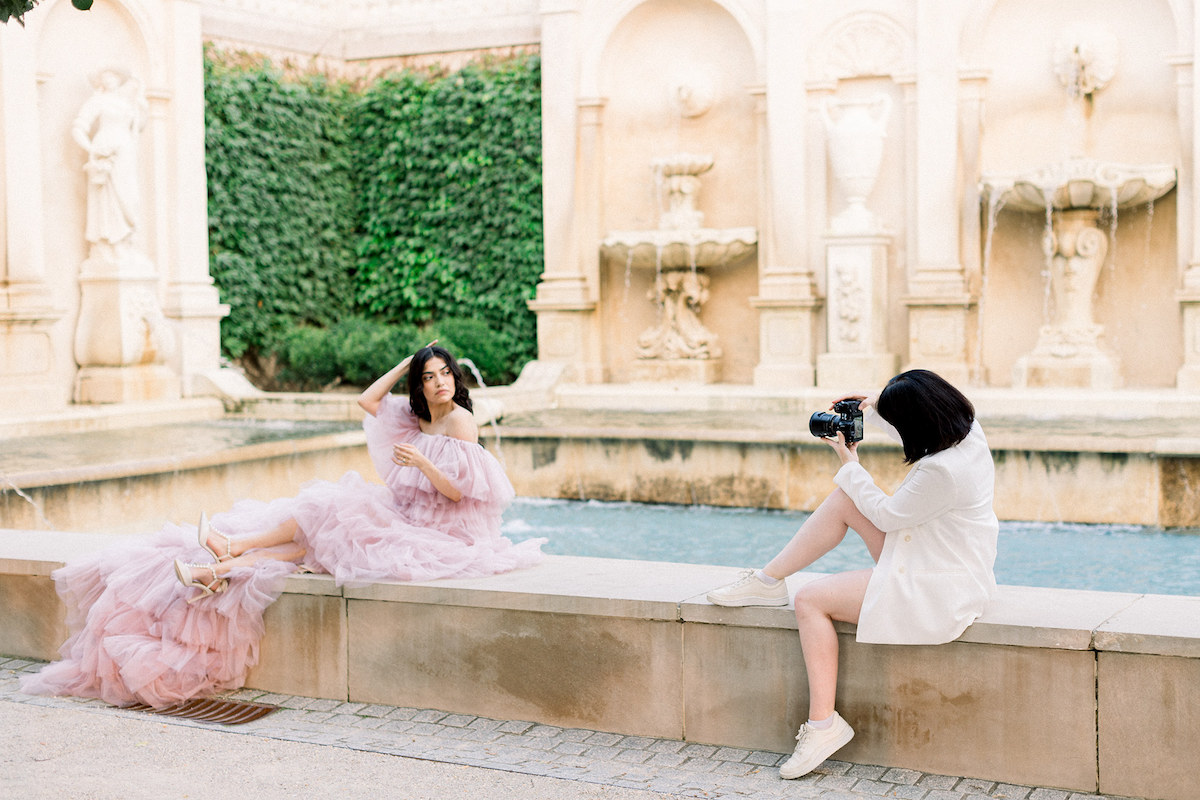 April Raymond, the creative force behind the editorial, directing Karla's pose while framing the shot amid the natural beauty of Longwood Gardens.