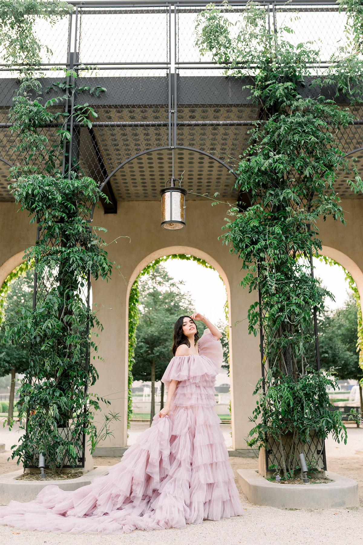 The couture gown transforms Karla into a vision of high-fashion chic, her commanding pose against the natural beauty of Longwood Gardens creating a captivating contrast