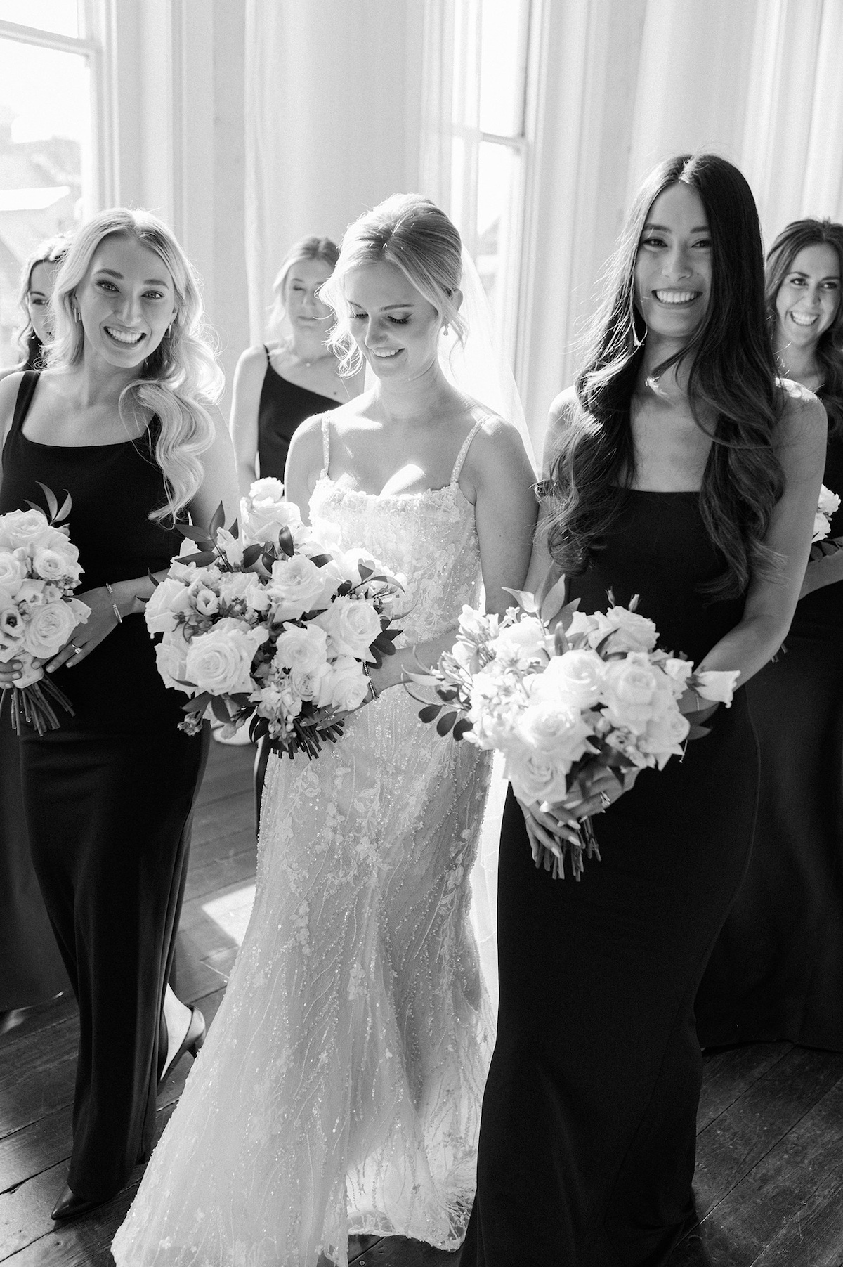 Candid editorial shot capturing the joyous camaraderie of bridesmaids, radiating sophistication in every moment.