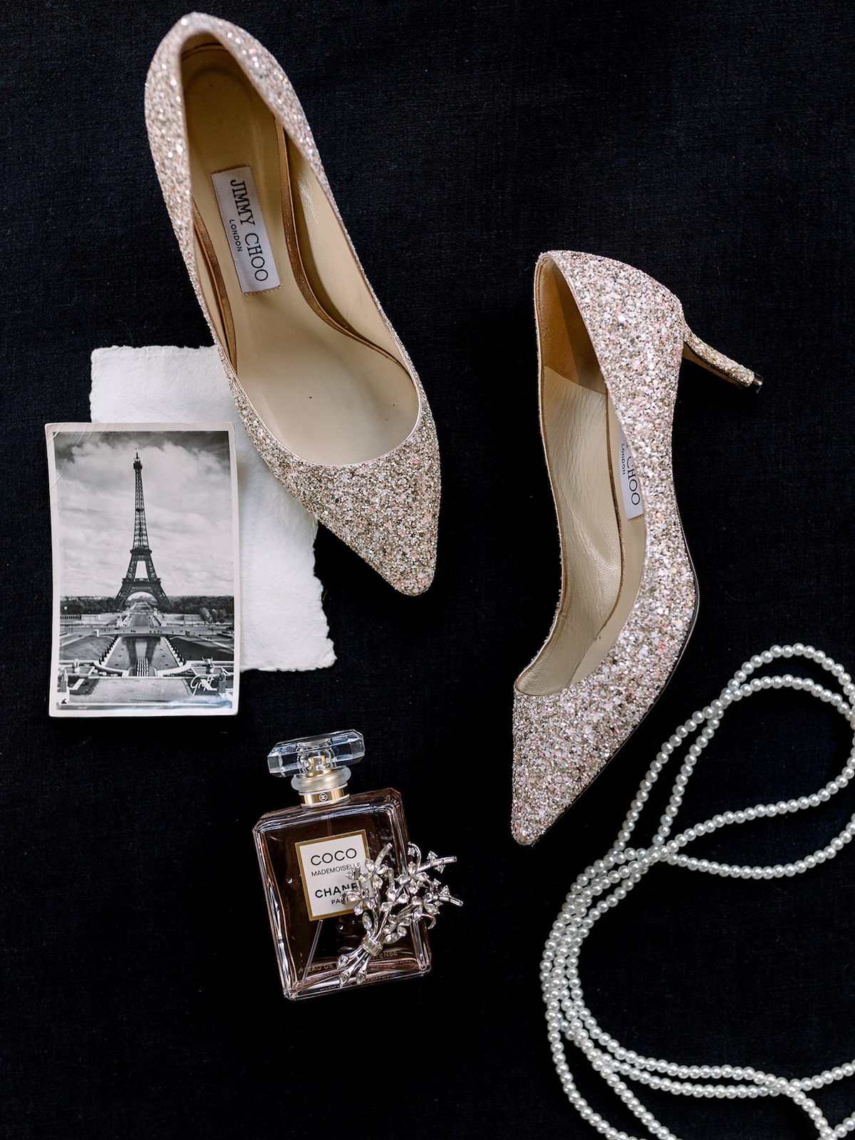 A meticulously styled flatlay showcasing the bride's accessories, from shoes to jewelry, in a display of refined taste.