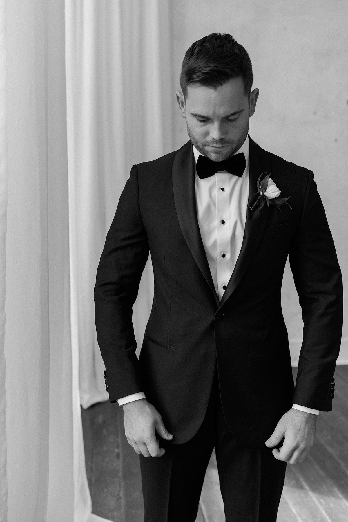 An editorial portrait capturing the groom's dapper elegance, showcasing high-end style and timeless sophistication.
