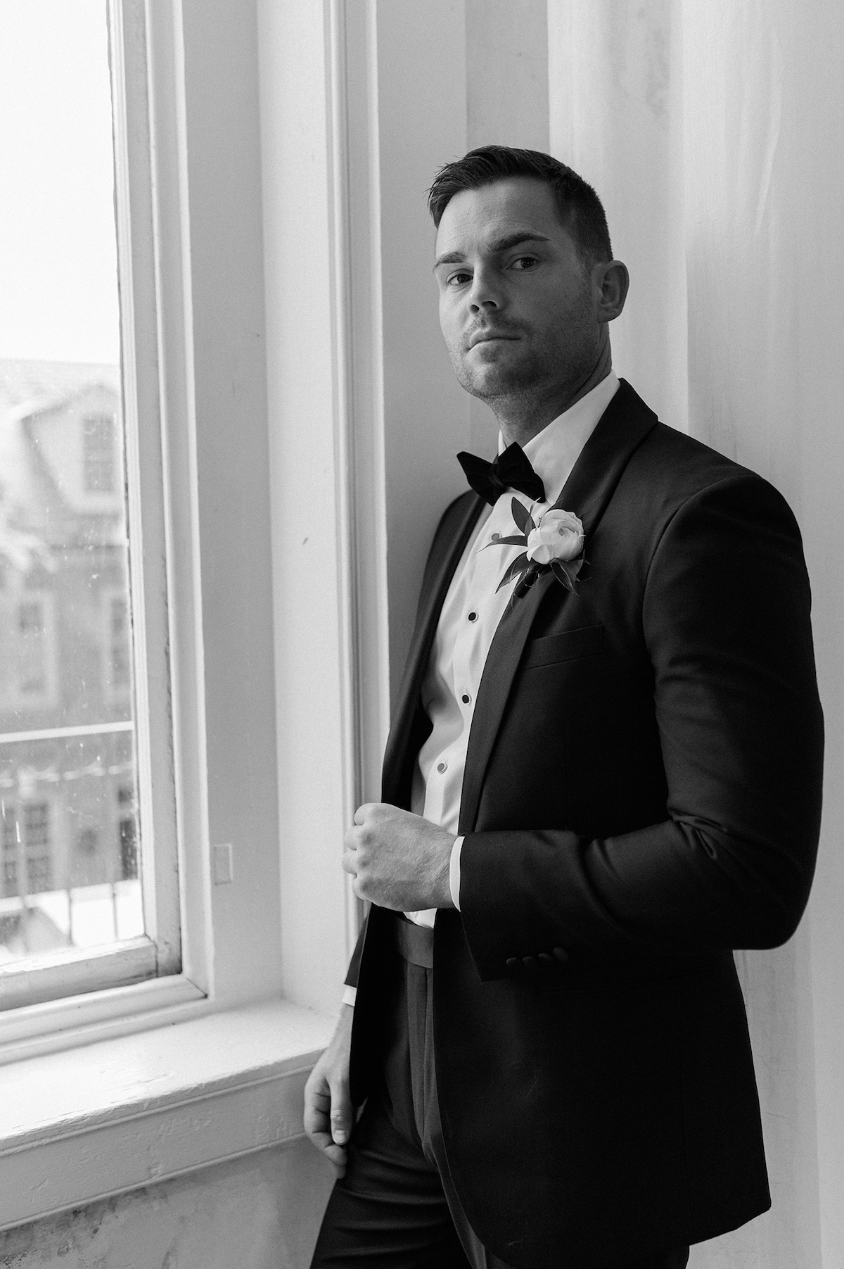 Timeless editorial portrait capturing the groom's gaze, expressing a mix of emotion and high-end sophistication.