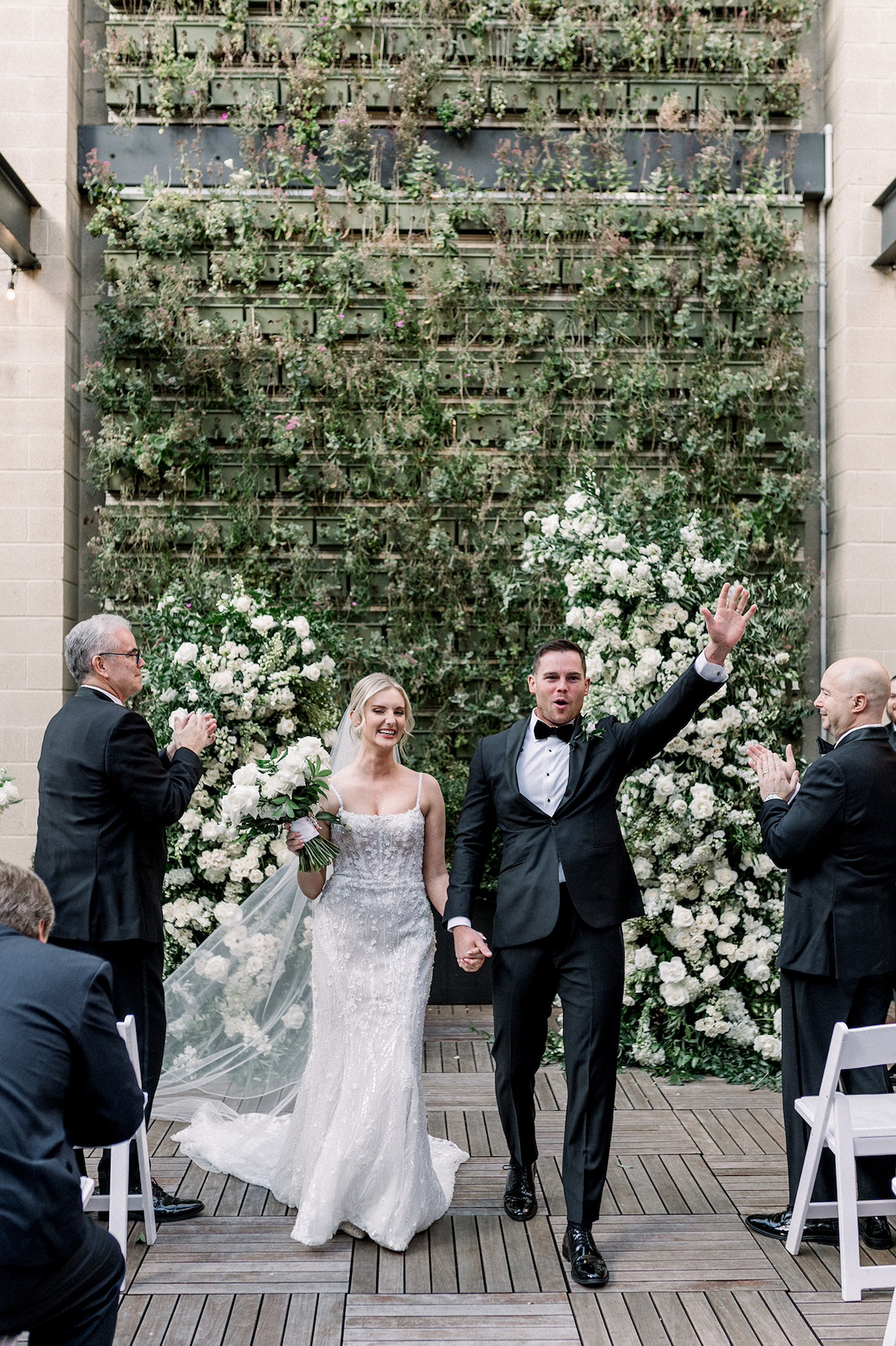 Joyful editorial moment during the recessional, celebrating the conclusion of the ceremony against the scenic allure of Excelsior Lancaster City.