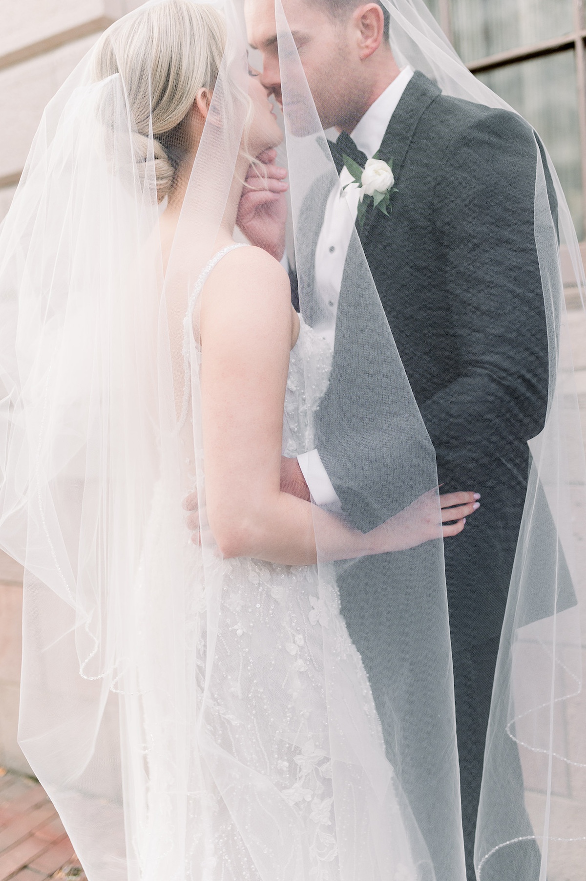 Lancaster City's elegance unfolds in this portrait featuring the bride's veil, a high-end capture of the delicate details against the city's classic charm.