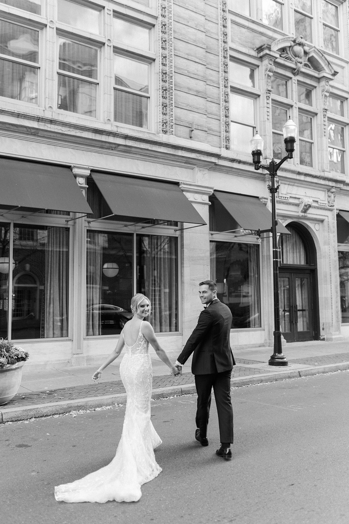 A romantic editorial moment as the bride and groom take a leisurely stroll through Lancaster City, portraying the high-end charm of their love.